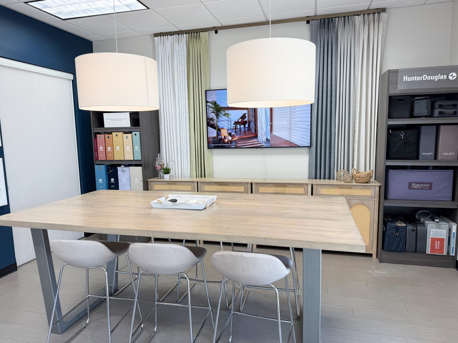 Inside the Cherry Grove showroom: the worktable, drapery wall, and product displays.