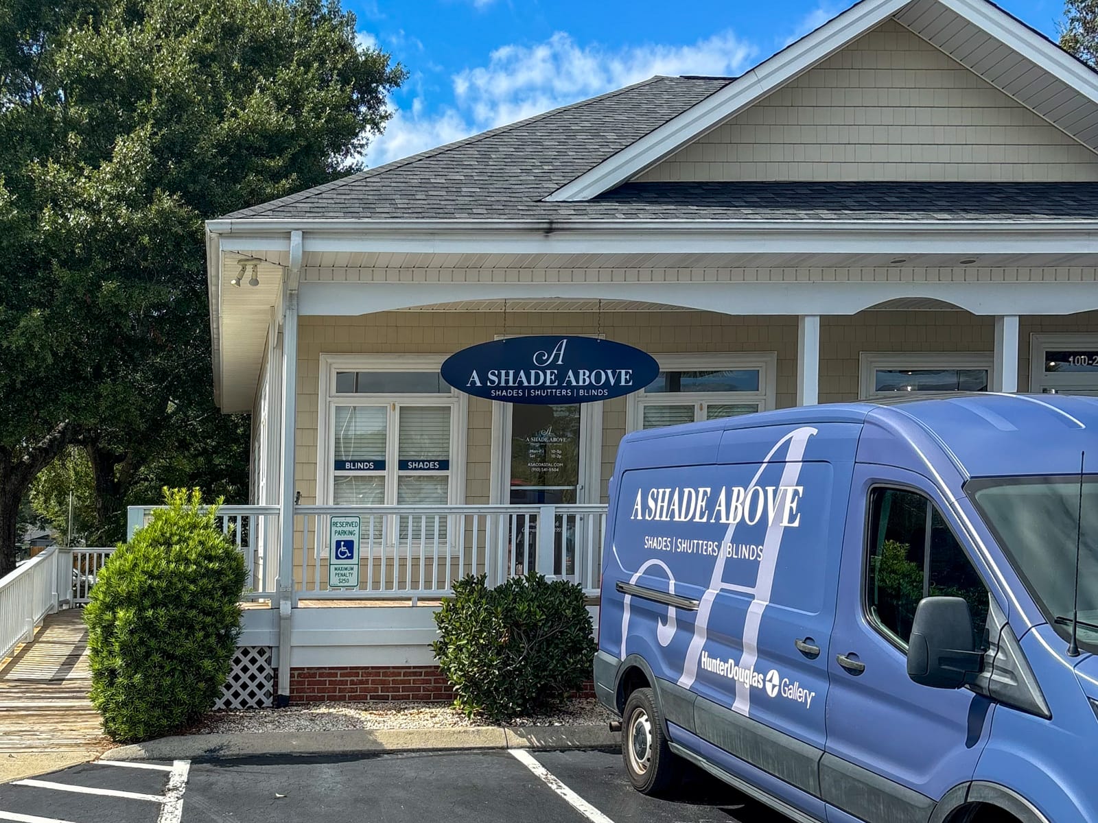 The Ocean Isle showroom: the yellow building with the long white porch, with the A Shade Above van out front.